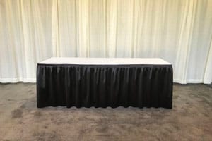 Table with black pleated skirting