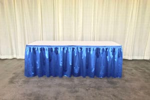 Table with blue pleated skirting
