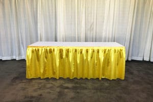 Table with gold pleated skirting