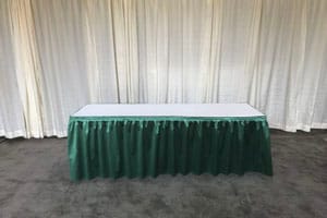 Table with green pleated skirting