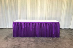 Table with purple pleated skirting