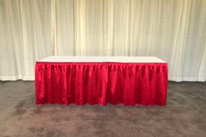 Table with red pleated skirting