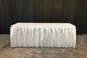 Table with silver pleated skirting